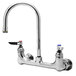 A chrome Equip by T&S wall mount faucet with 2 lever handles and a gooseneck spout.