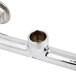 A chrome plated Equip by T&S wall mounted faucet base with wrist handles and cerama cartridges.