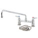 A T&S chrome deck-mounted faucet with a swing spout and lever handles.