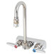 A silver T&S wall mounted faucet with lever handles.