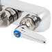 A chrome wall mounted T&S workboard faucet with blue lever handles.