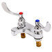 A T&S chrome deck mounted faucet with wrist handles in red and blue.