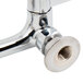 A chrome plated Equip by T&S wall mount faucet with gooseneck spout and wrist handles.