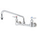 A T&S chrome wall mounted faucet with two lever handles.