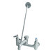 A T&S chrome wall mounted mop sink faucet with lever handles and a garden hose outlet.
