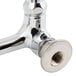 A T&S chrome wall mounted faucet with lever handles.