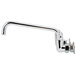 A chrome Equip by T&S wall mounted faucet with wrist handles and a swing spout.
