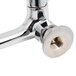 A chrome plated Equip by T&S wall mount faucet with wrist handles and a swing spout.