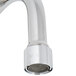 A close-up of a chrome T&S wall mount faucet with lever handles.