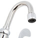 A T&amp;S chrome wall mounted faucet with a wrist handle and gooseneck spout.