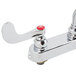 A T&S deck-mounted workboard faucet with white wrist handles.