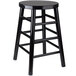 A Lancaster Table & Seating black metal counter height stool with a round wooden seat.