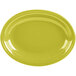 A yellow oval medium china platter with a rim on a white background.
