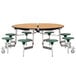 A National Public Seating round cafeteria table with green MDF seats on metal legs.