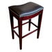 A Holland Bar Stool Lynn espresso wood counter height stool with black vinyl saddle seat.