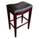 A Holland Bar Stool Lynn Espresso wood bar height stool with a black vinyl saddle seat.