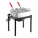 A stainless steel Backyard Pro dual basket fryer with red and white handles on a stand.