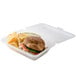 A sandwich and chips in a clear customizable plastic container.