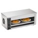 A Vollrath stainless steel countertop cheese melter with two plates of food.