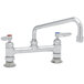 A T&S chrome deck-mounted pantry faucet with lever handles.