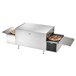 A Vollrath countertop conveyor oven with pizza cooking on the belt.