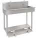 An Advance Tabco stainless steel utility sink with two toe-operated faucets.