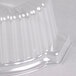 A clear plastic container with a curved edge and a clear plastic dome lid.