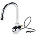 A chrome wall mounted Equip by T&amp;S sensor faucet with a swivel gooseneck spout and a white thermostatic mixing valve.