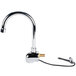 A white and chrome Equip by T&amp;S wall mounted sensor faucet with a gold handle and a swivel gooseneck spout.