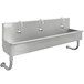 A stainless steel Advance Tabco multi-station utility sink with 3 faucets.