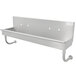 An Advance Tabco stainless steel wall mounted multi-station hand sink with 4 faucets.