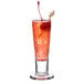 A Libbey cordial glass filled with a drink and a cherry on top.