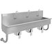 A stainless steel Advance Tabco multi-station hand sink with 3 knee operated faucets.