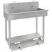 An Advance Tabco stainless steel multi-station hand sink with 3 toe operated faucets.