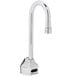 A silver T&S wall mounted faucet with a long gooseneck spout and a black button.