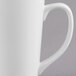 A close-up of a Libbey white porcelain tall bistro mug with a handle.