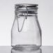 A Tablecraft clear glass salt and pepper shaker with a stainless steel clip-top lid.
