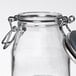 A Tablecraft glass salt and pepper shaker jar with a stainless steel clip-top lid.