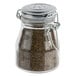 A Tablecraft glass jar with a stainless steel clip-top lid.