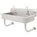 A stainless steel Advance Tabco hand sink with four electronic faucets.