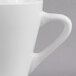 A close-up of the handle of a Libbey white espresso cup.