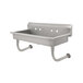 A stainless steel wall mounted Advance Tabco hand sink with 5 faucet holes.