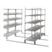 A Metro qwikTRAK stainless steel double deep stationary intermediate unit with shelves and wheels.