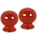 A pair of red Fiesta salt and pepper shakers.