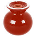 A red ceramic salt and pepper shaker with a white rim.