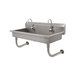 An Advance Tabco stainless steel hand sink with two electronic faucets.
