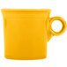 A yellow China mug with a handle.