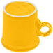 A yellow mug with a handle.
