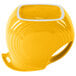 A yellow and white striped disc pitcher with a yellow liquid inside and a white rim.