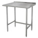 An Advance Tabco stainless steel work table with legs and a backsplash.